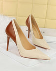 Pair of high-heeled shoes with brown and beige color scheme on a white surface.
