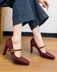 Maroon high-heeled Mary Jane sandals with a gold buckle