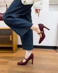 Maroon high-heeled Mary Jane sandals with a gold buckle