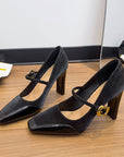 black high-heeled Mary Jane sandals with a gold buckle