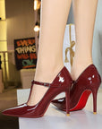 Red patent-look T-strap pointed-toe stiletto heels with 10 cm heel and buckle strap
