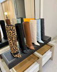 Black Givenchy Style knee-high boot with a gold buckle
