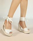 Patent hollow wedge platform heels with ribbon ankle cuff for women by VÈRV.