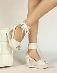 Patent hollow wedge platform heels with ribbon ankle cuff for women by VÈRV.