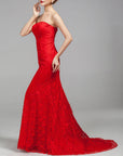 Woman wearing a red strapless gown on a gray background