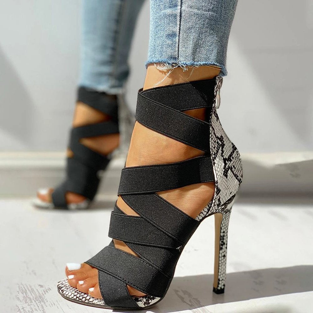 Black strappy high-heeled shoes with snake print