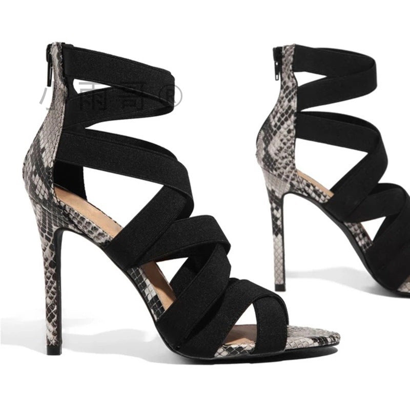 Black strappy high-heeled shoes with snake print