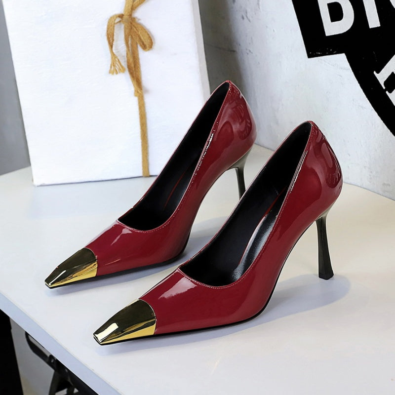 Red high-heeled shoes with gold metal accents 