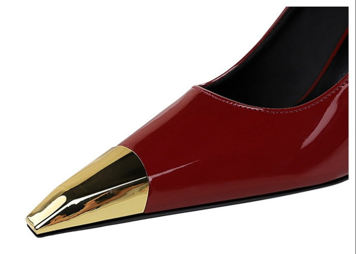 Red high-heeled shoes with gold metal accents 
