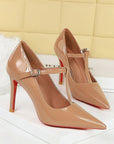 Nude patent-look T-strap pointed-toe stiletto heels with 10 cm heel and buckle strap
