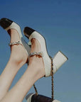 Celine black and white two-tone Mary Jane block heels with glossy cap toe and metallic strap detail by VÈRV