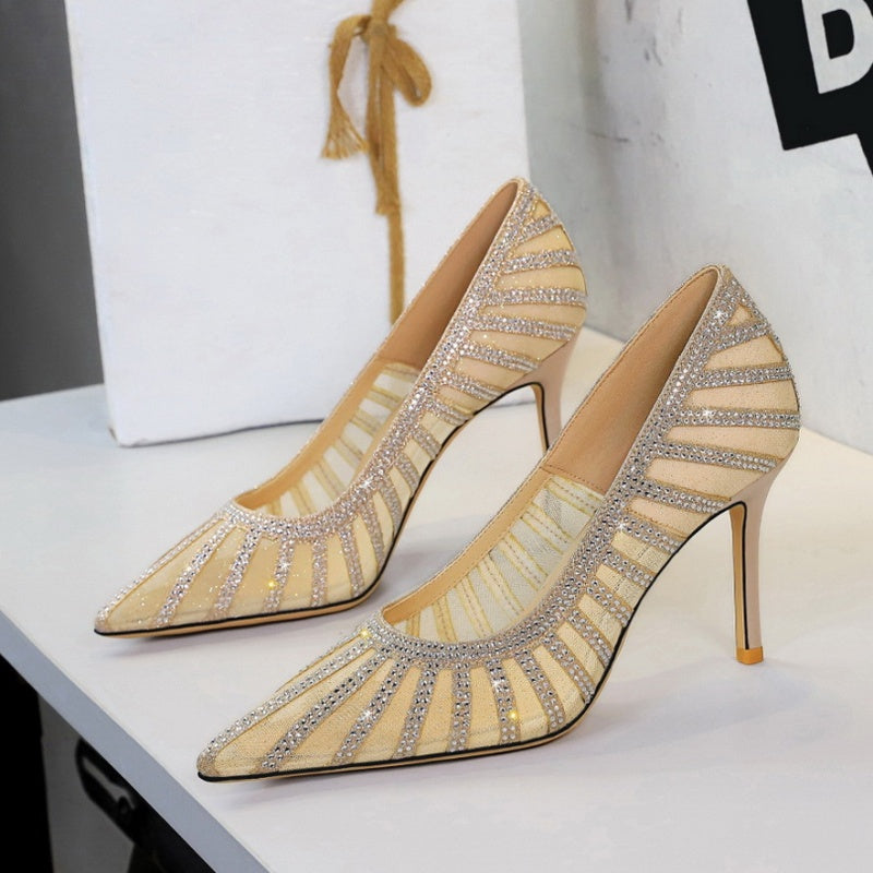Gold high-heeled shoes with rhinestone details