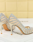 Silver high-heeled shoes with rhinestone details