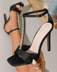 Black high-heeled sandals with rhinestone straps 