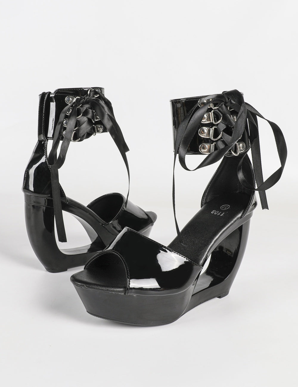 Black patent hollow wedge platform heels with ribbon ankle cuff for women by VÈRV.