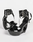 Black patent hollow wedge platform heels with ribbon ankle cuff for women by VÈRV.