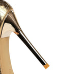 Gold high-heeled shoe with a cracked pattern 